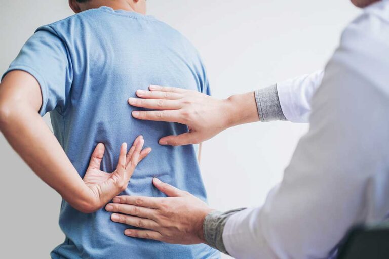 A chiropractor gently performing a spinal adjustment on a patient in a calm clinical setting.